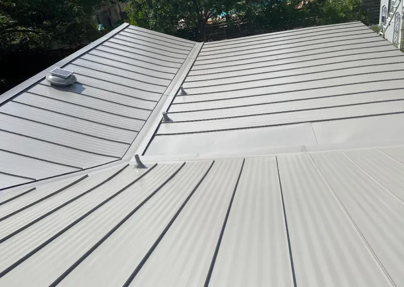 Solar attic fan installed on a metal roof for Roof Ventilation in Bellevue